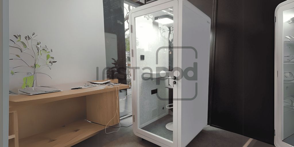 Modern self-contained pod in a minimalist indoor setting.