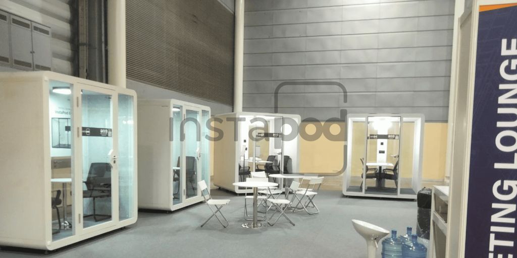 Two modern phone booths in a minimalist interior space.