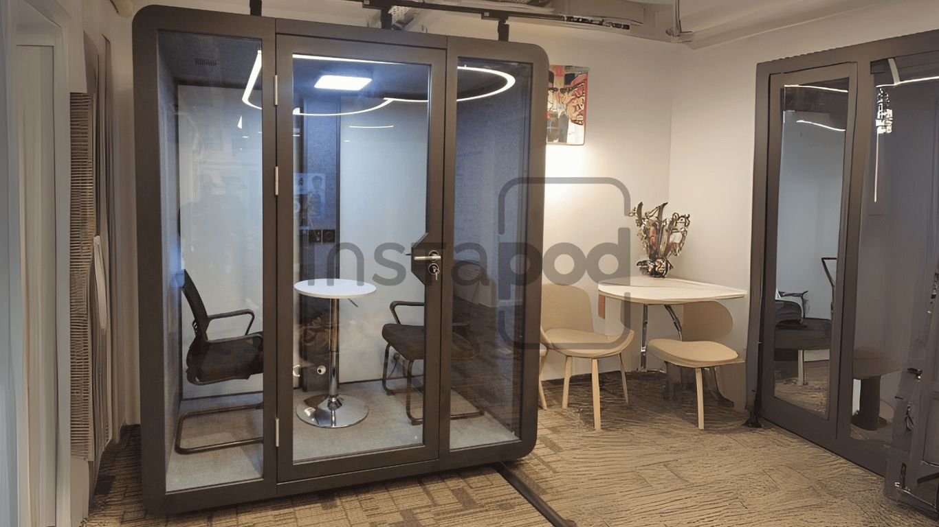 Modern workspace with a soundproof booth and seating area.