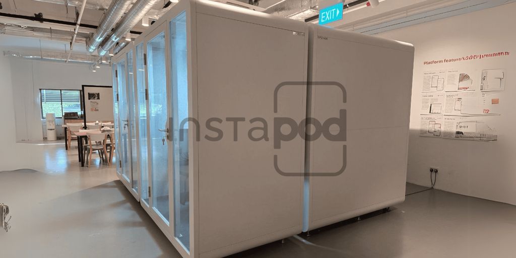 Modern office space featuring modular white work pods.
