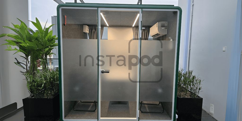 Modern soundproof pod with plants, designed for privacy and comfort.