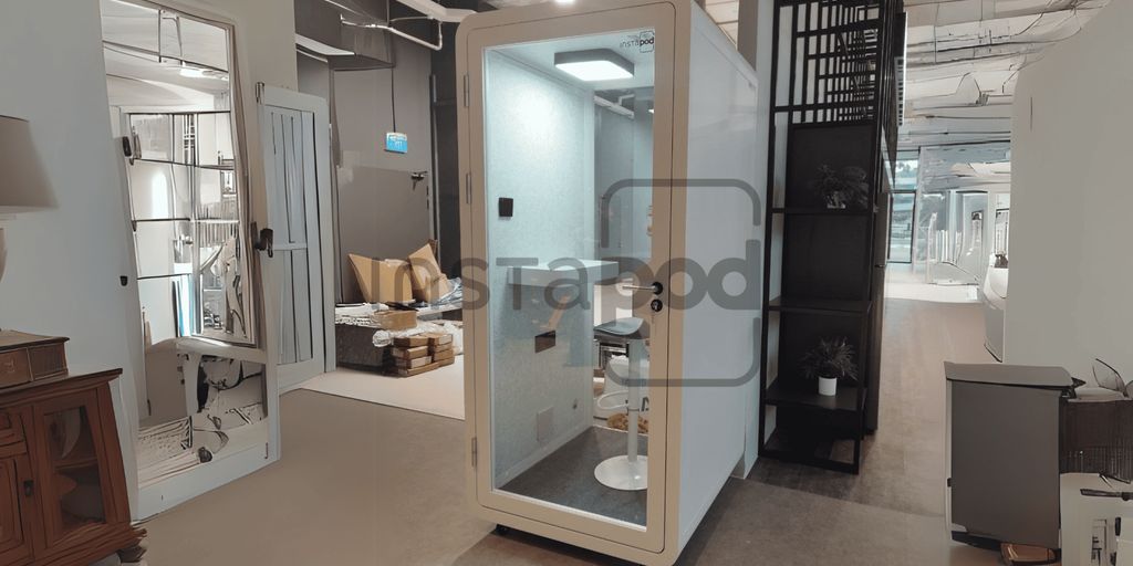 Modern soundproof pod in a stylish office environment.