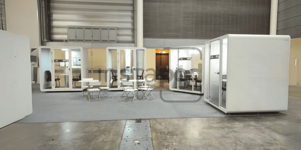 A modern office space with individual work pods and seating.