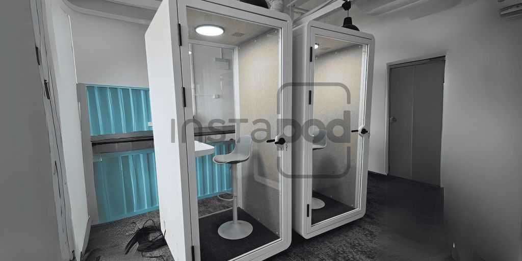 Two modern soundproof booths with minimalistic design and furniture.