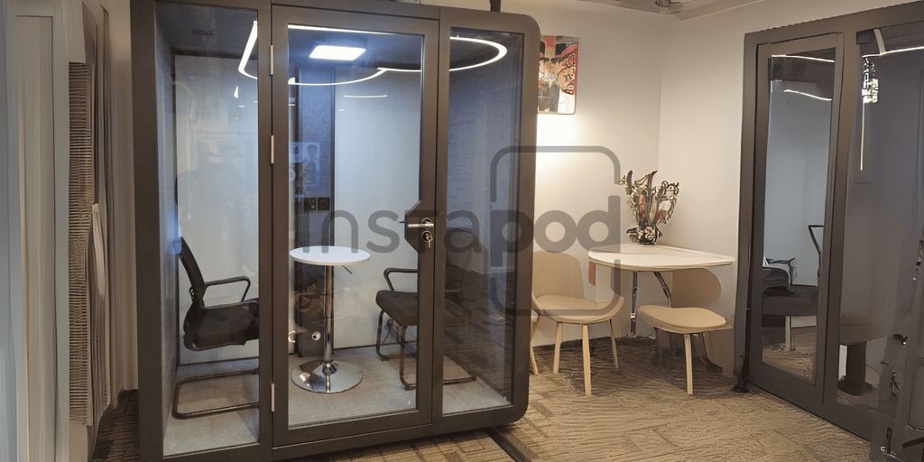 Modern workspace with a soundproof booth and seating area.