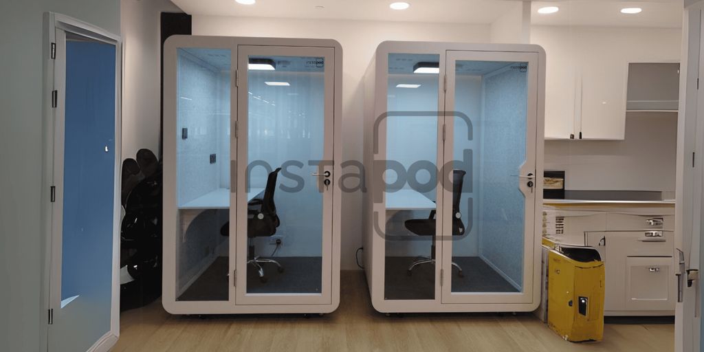 Two soundproof work pods in a modern office space.