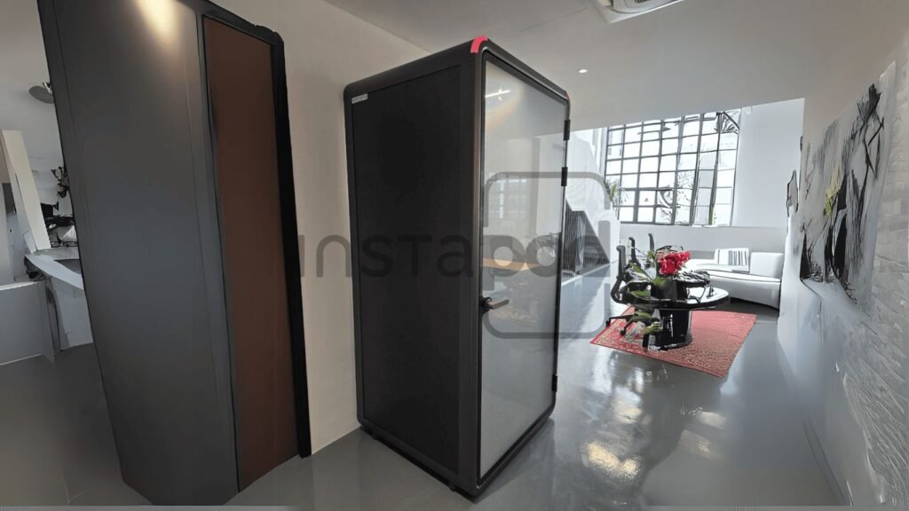 Modern interior featuring a transparent booth and stylish decor.