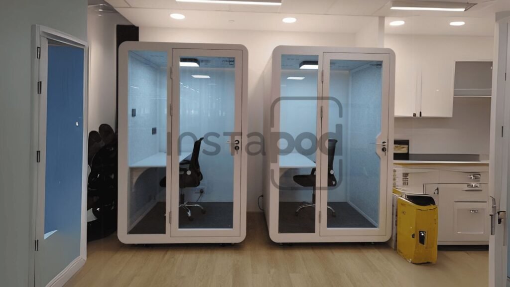 Two soundproof work pods in a modern office space.