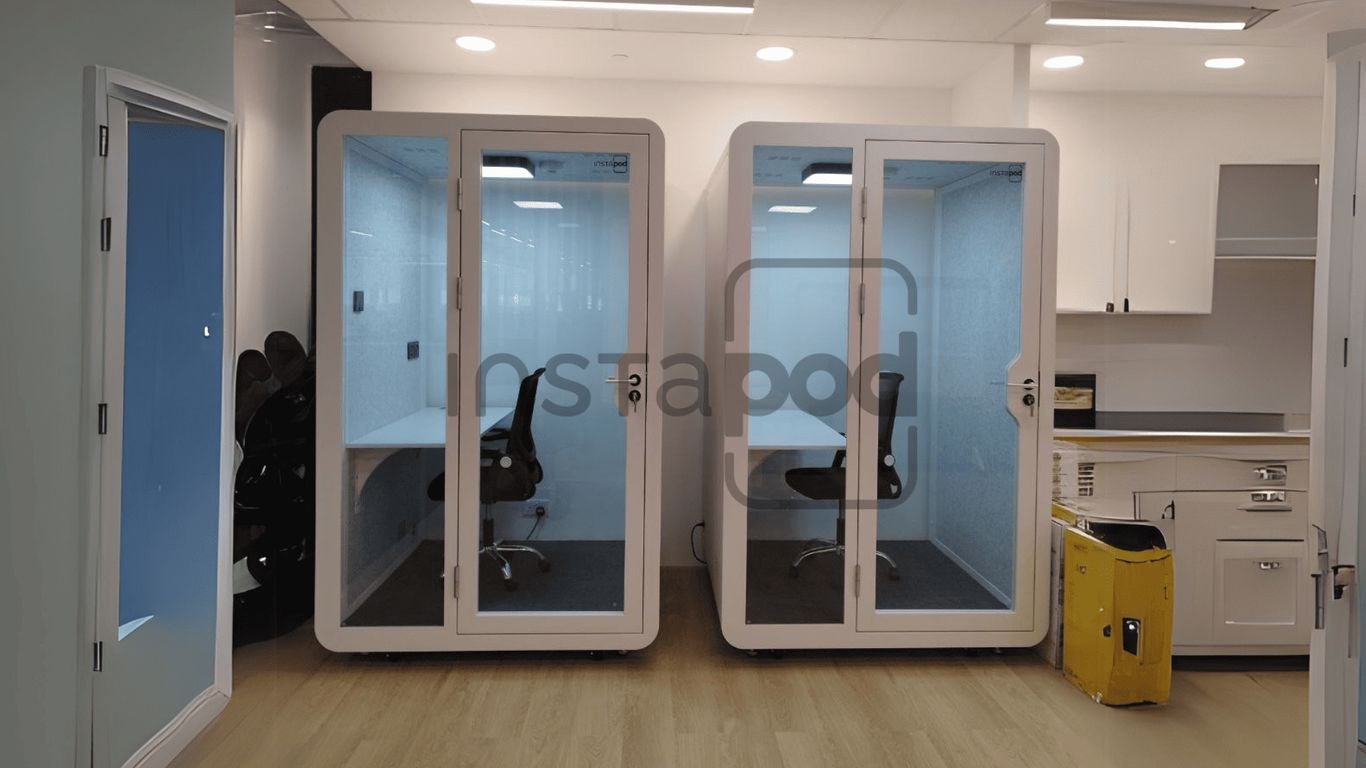 Two soundproof work pods in a modern office space.