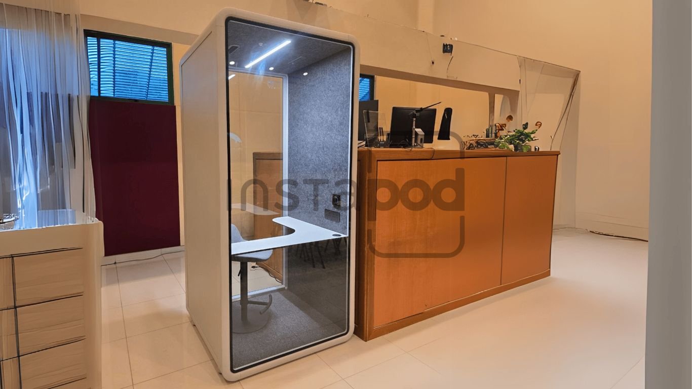 Modern workspace featuring a privacy pod and reception area.