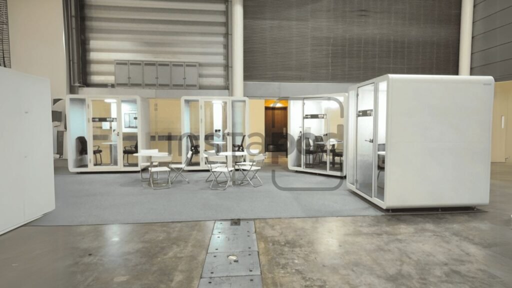 A modern office space with individual work pods and seating.