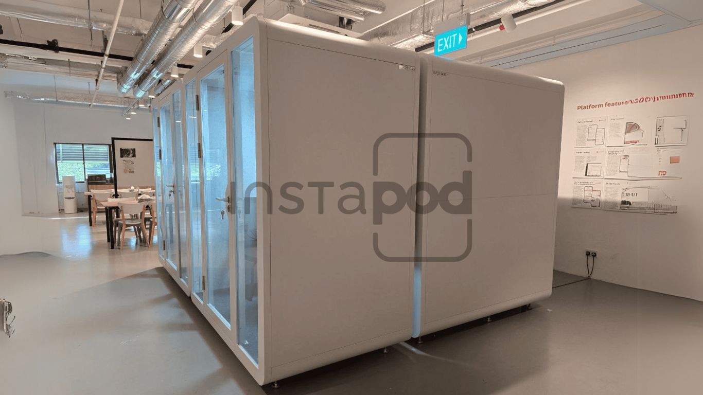 Modern office space featuring modular white work pods.