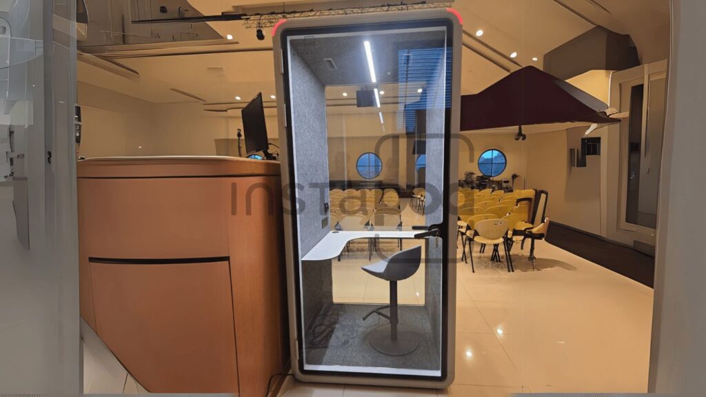 Modern workspace with a soundproof booth and seating area.