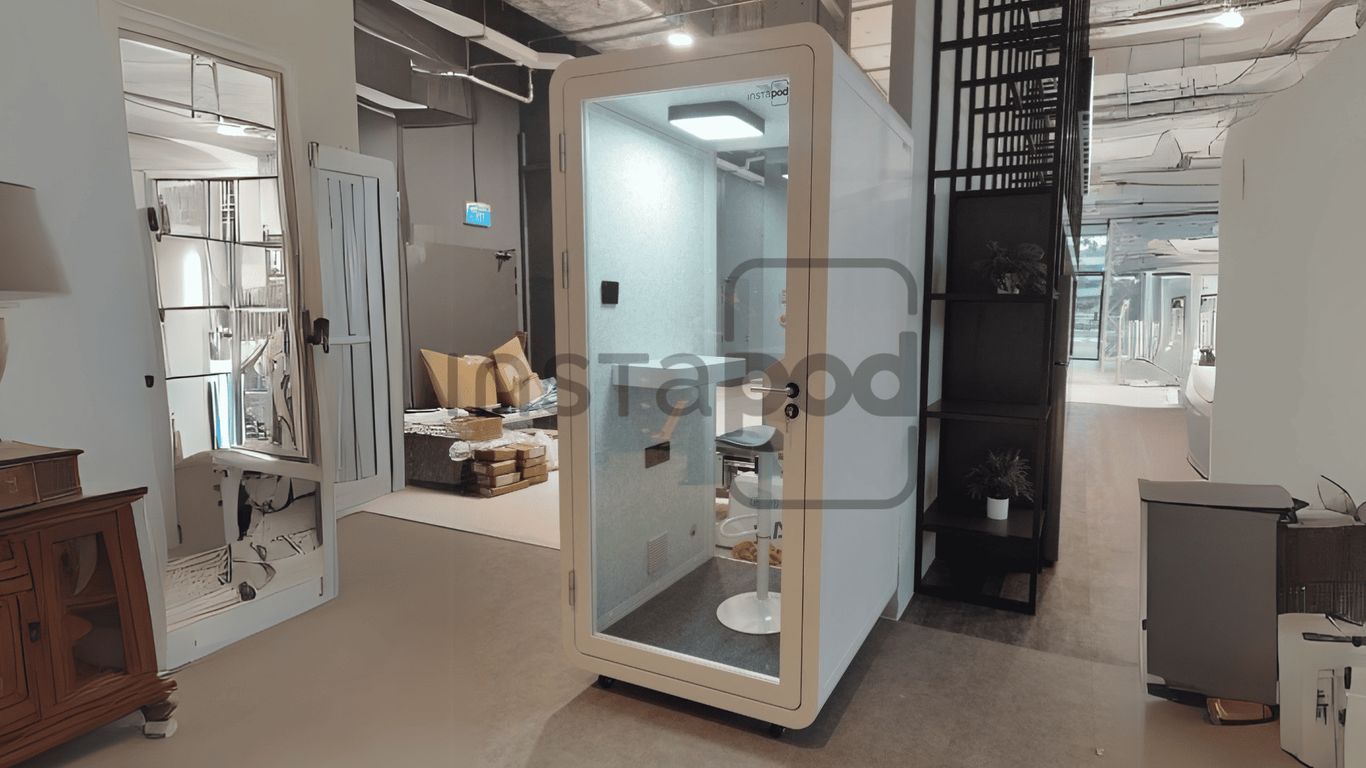 Modern soundproof pod in a stylish office environment.