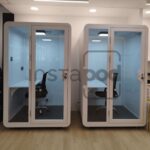 Two soundproof work pods in a modern office space.