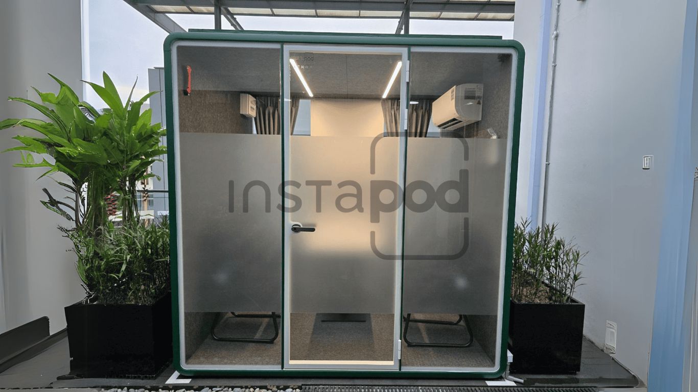 Modern soundproof pod with plants, designed for privacy and comfort.