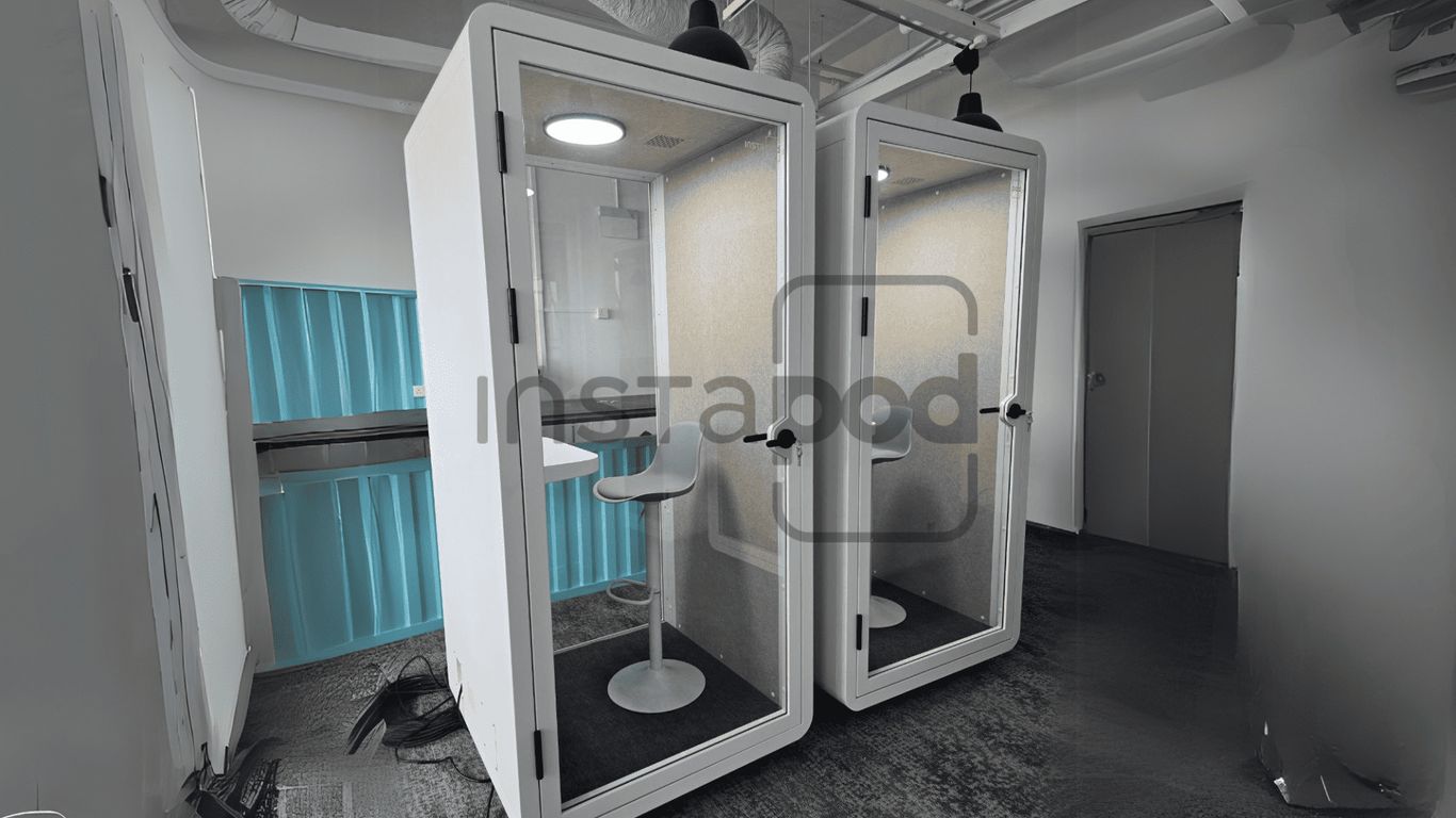 Two modern soundproof booths with minimalistic design and furniture.