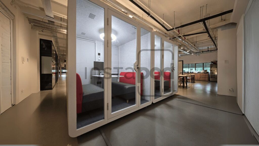 Modern office space featuring meeting pods and comfortable seating.